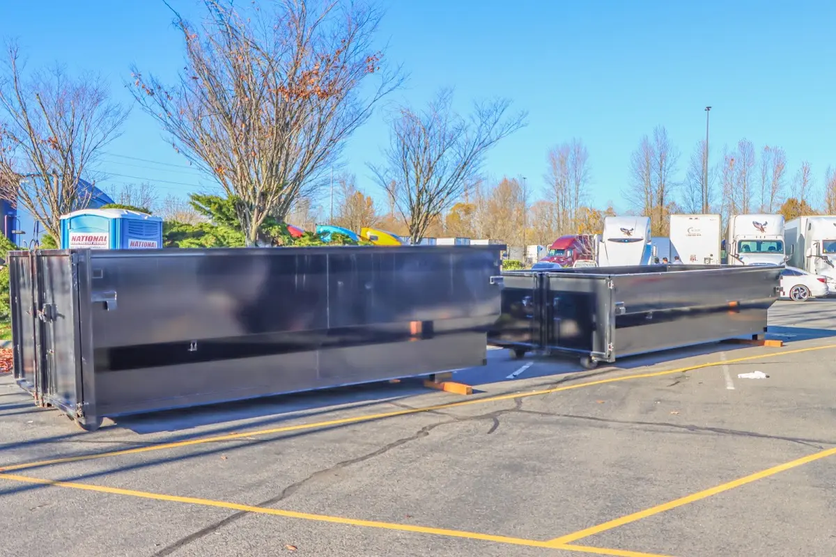 Professional dumpster rental service with roll-off container on residential driveway in Chicopee